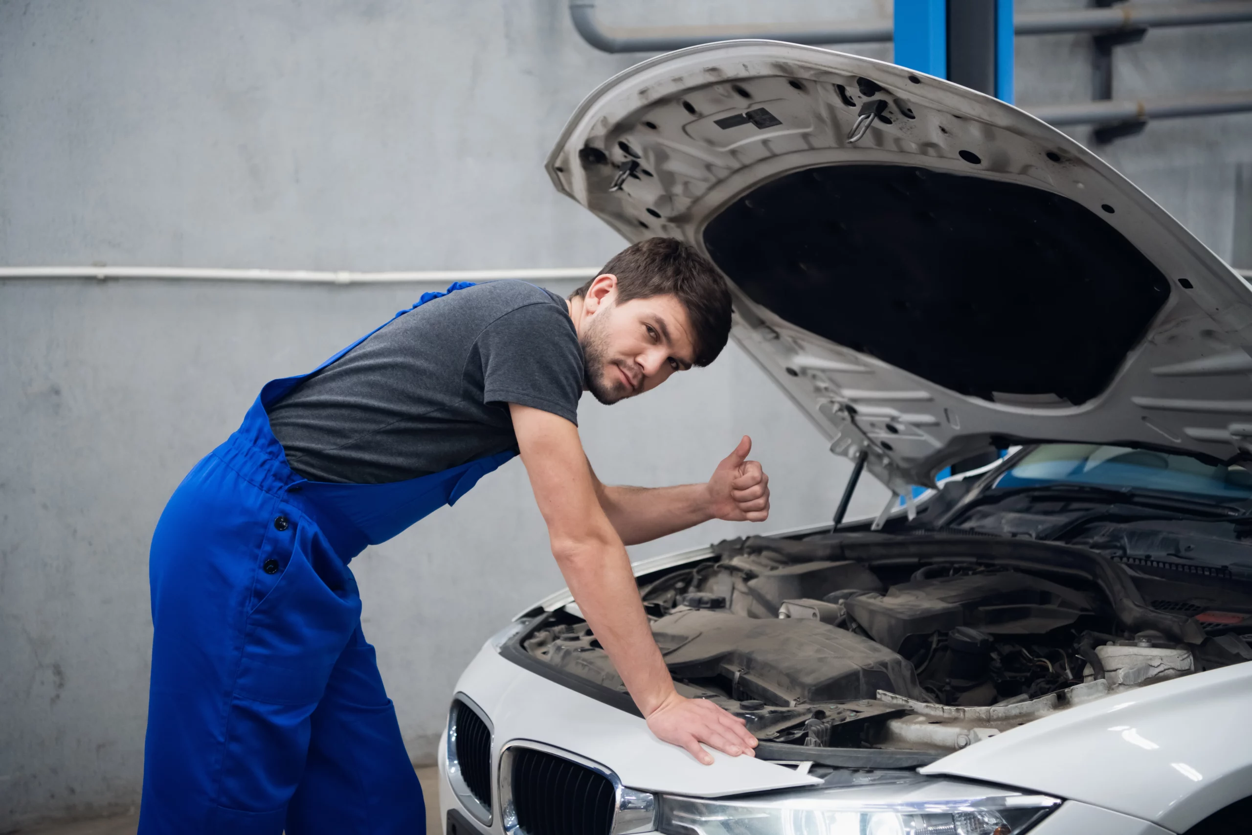 mechanic-stands-by-open-hood-car-shows-thumb